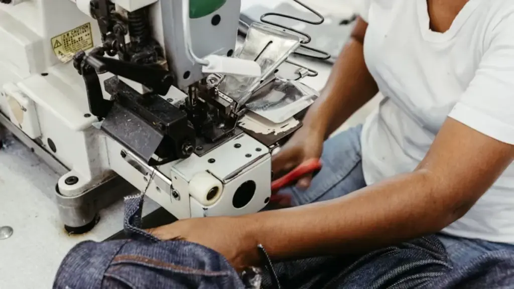 a woman is working on a sewing machine