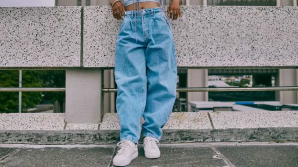 a woman in baggy denim jeans