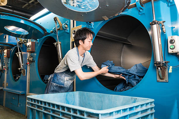 Textile worker looking confident in a large washing plant