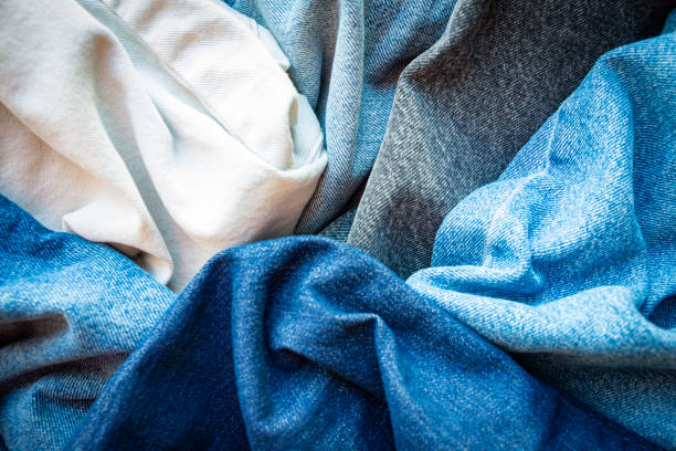 Various shades and colors of denim fabrics. Denim texture background.