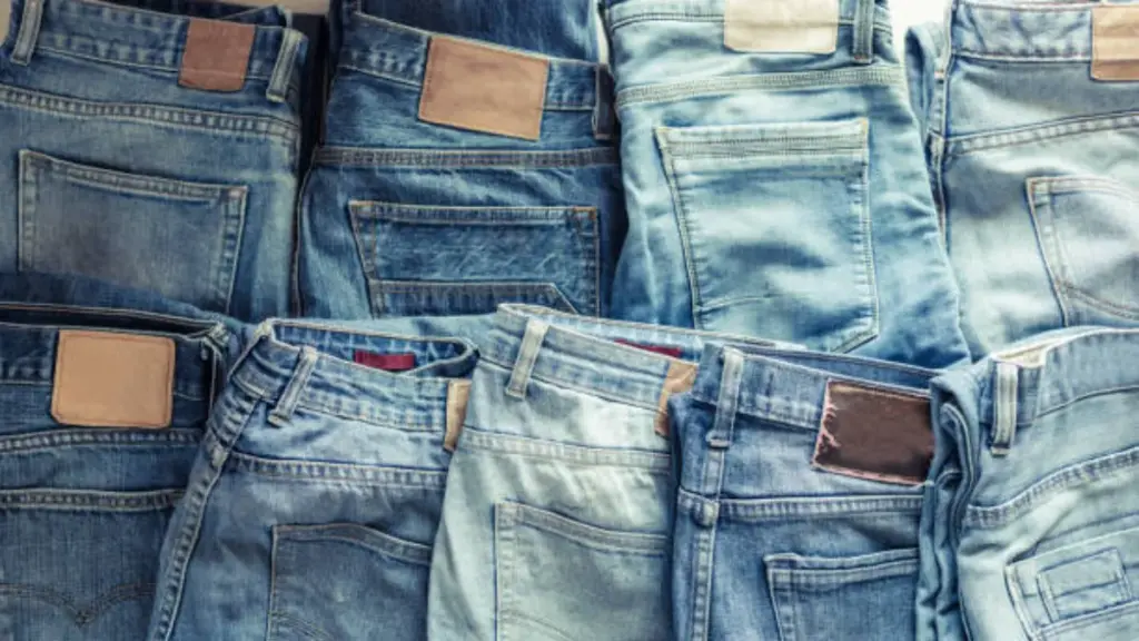 several washed denim jeans